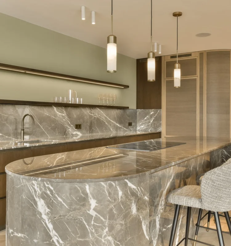 a-kitchen-with-a-marble-counter-top-and-three-chai-2025-02-10-13-45-26-utc